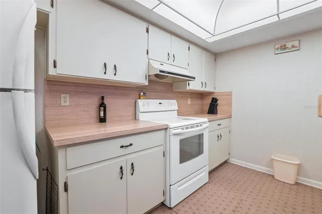 a kitchen with cabinets appliances and a sink