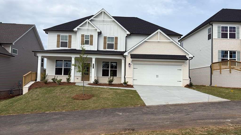 a front view of a house with a yard and garage