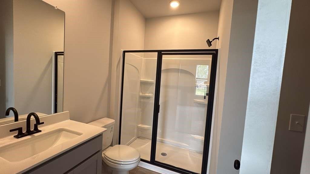 2666 Harbor Rdg Pass Gainesville, GA 30507 - Photo 12 of 41 a bathroom with a toilet a sink and a mirror