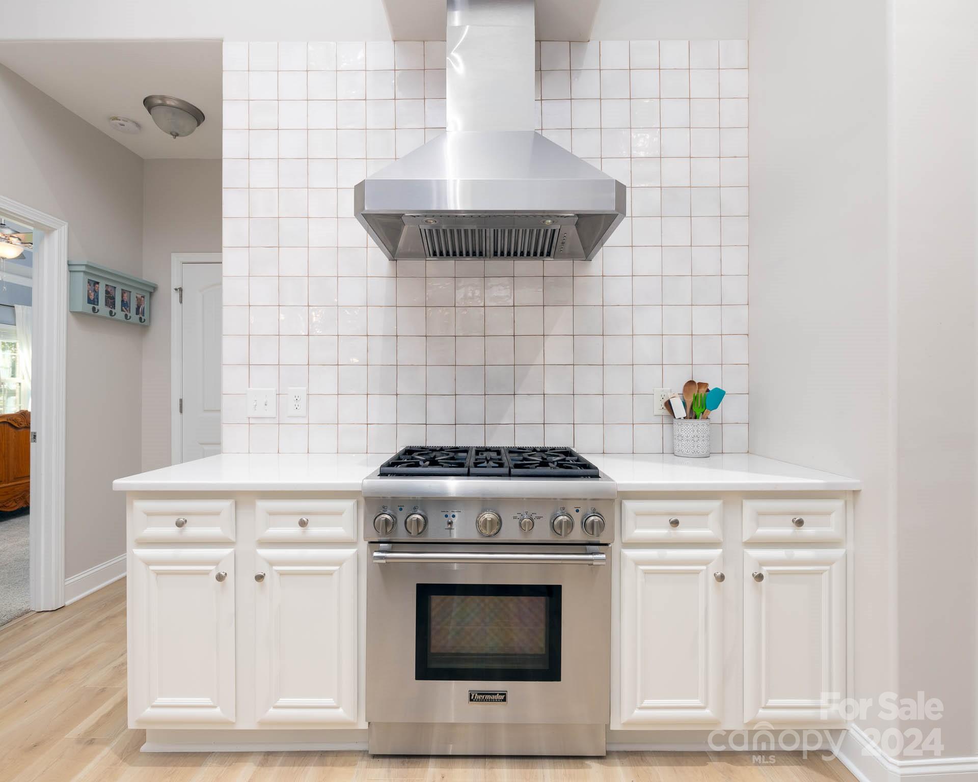 706 Houston Road Troutman, NC 28166 - Photo 12 of 39 a stove top oven sitting inside of a kitchen