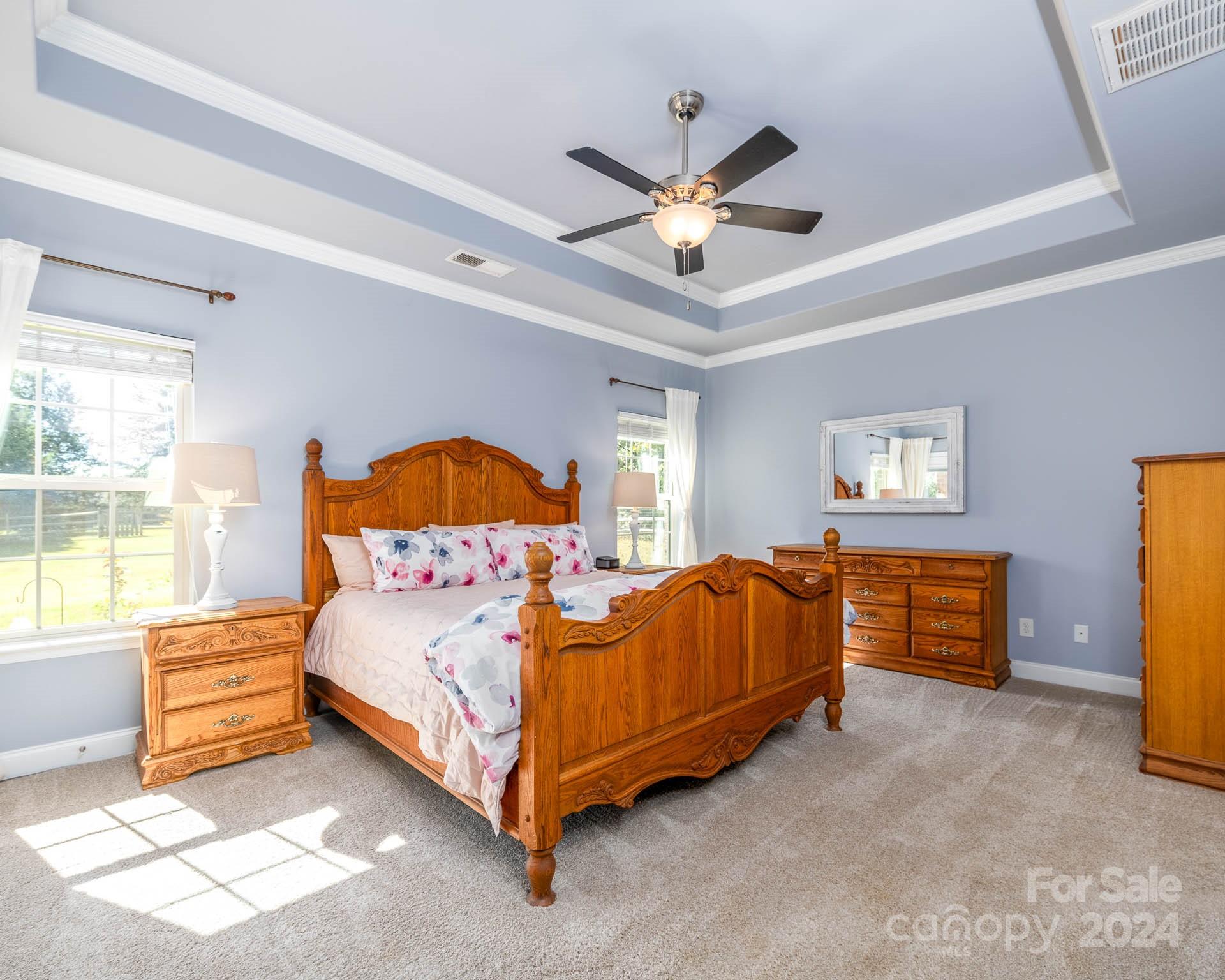 706 Houston Road Troutman, NC 28166 - Photo 15 of 39 a bedroom with a bed and a chandelier
