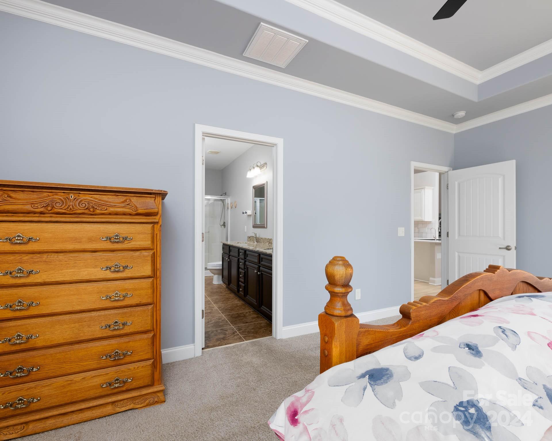 706 Houston Road Troutman, NC 28166 - Photo 17 of 39 a bedroom with a bed and a lamp on the dresser