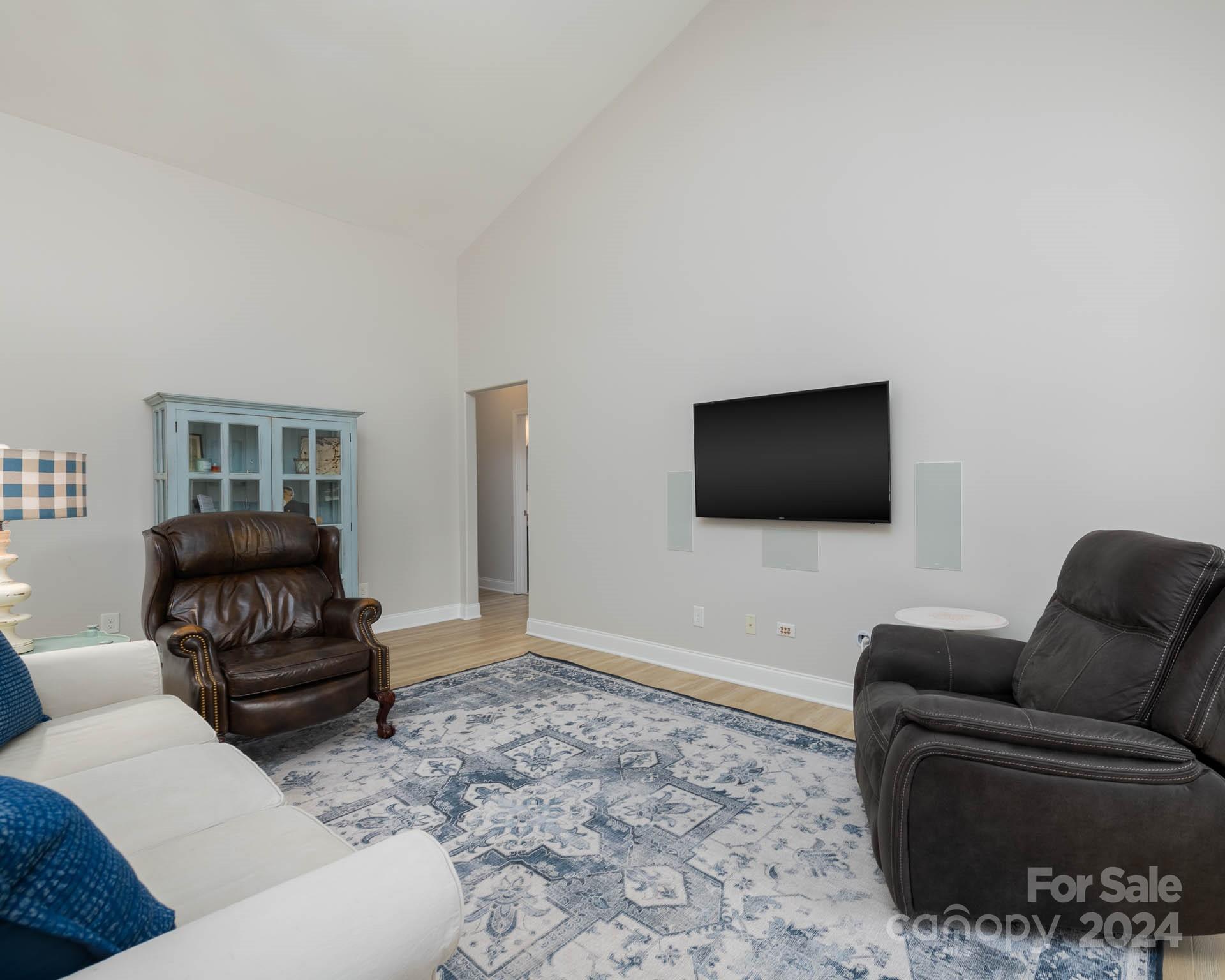 706 Houston Road Troutman, NC 28166 - Photo 21 of 39 a living room with furniture and a flat screen tv