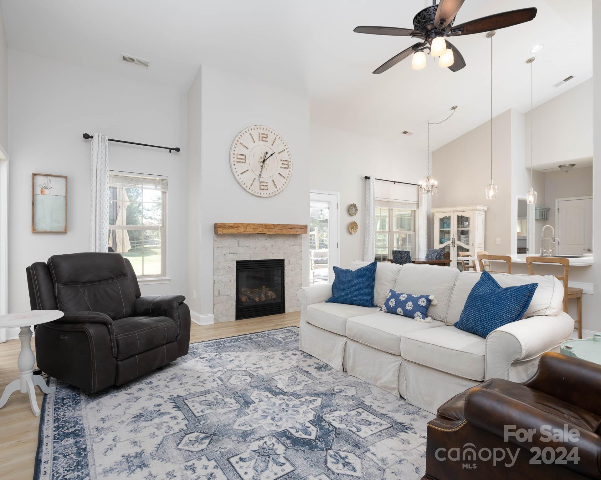 706 Houston Road Troutman, NC 28166 - Photo 22 of 39 a living room with furniture a fireplace and a large window