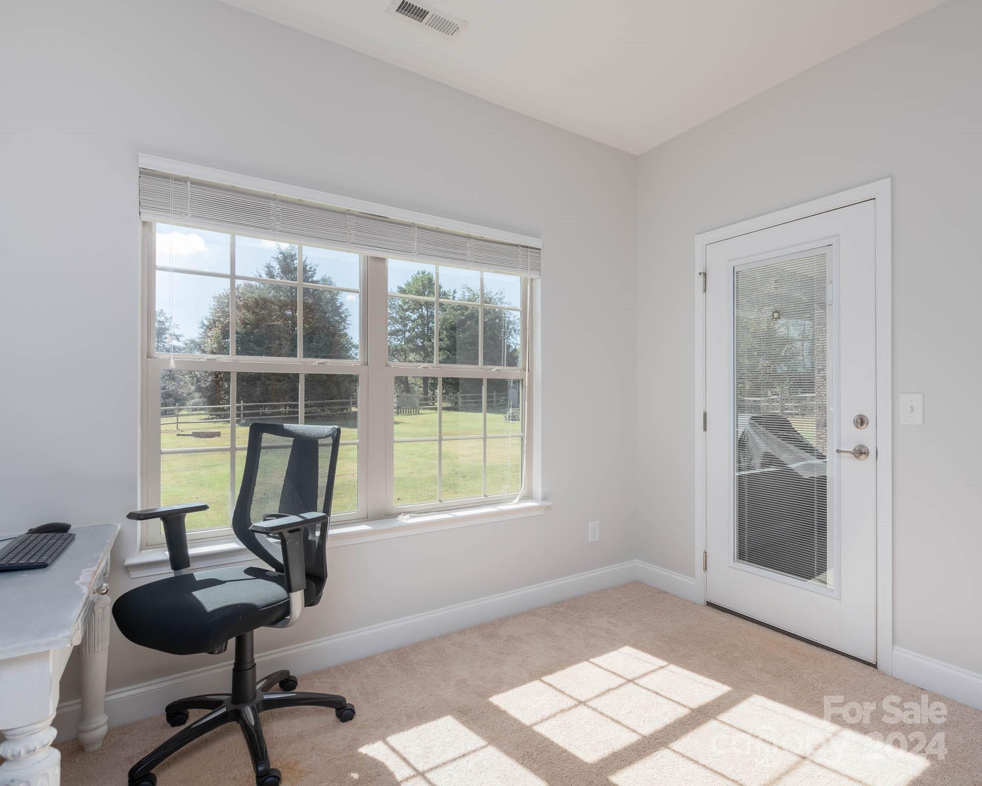 706 Houston Road Troutman, NC 28166 - Photo 24 of 39 a view of a workspace with furniture and a window