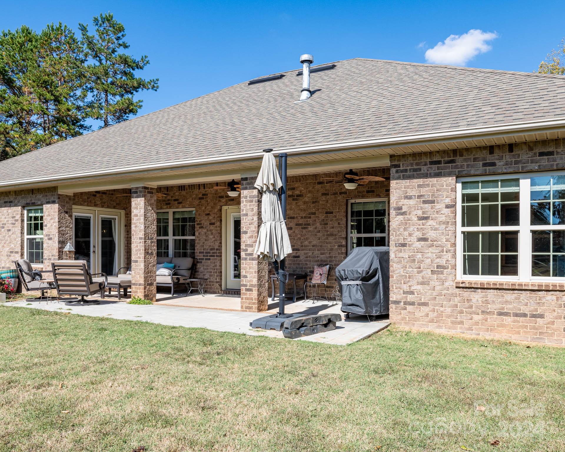 706 Houston Road Troutman, NC 28166 - Photo 29 of 39 a view of a house with patio outdoor seating area
