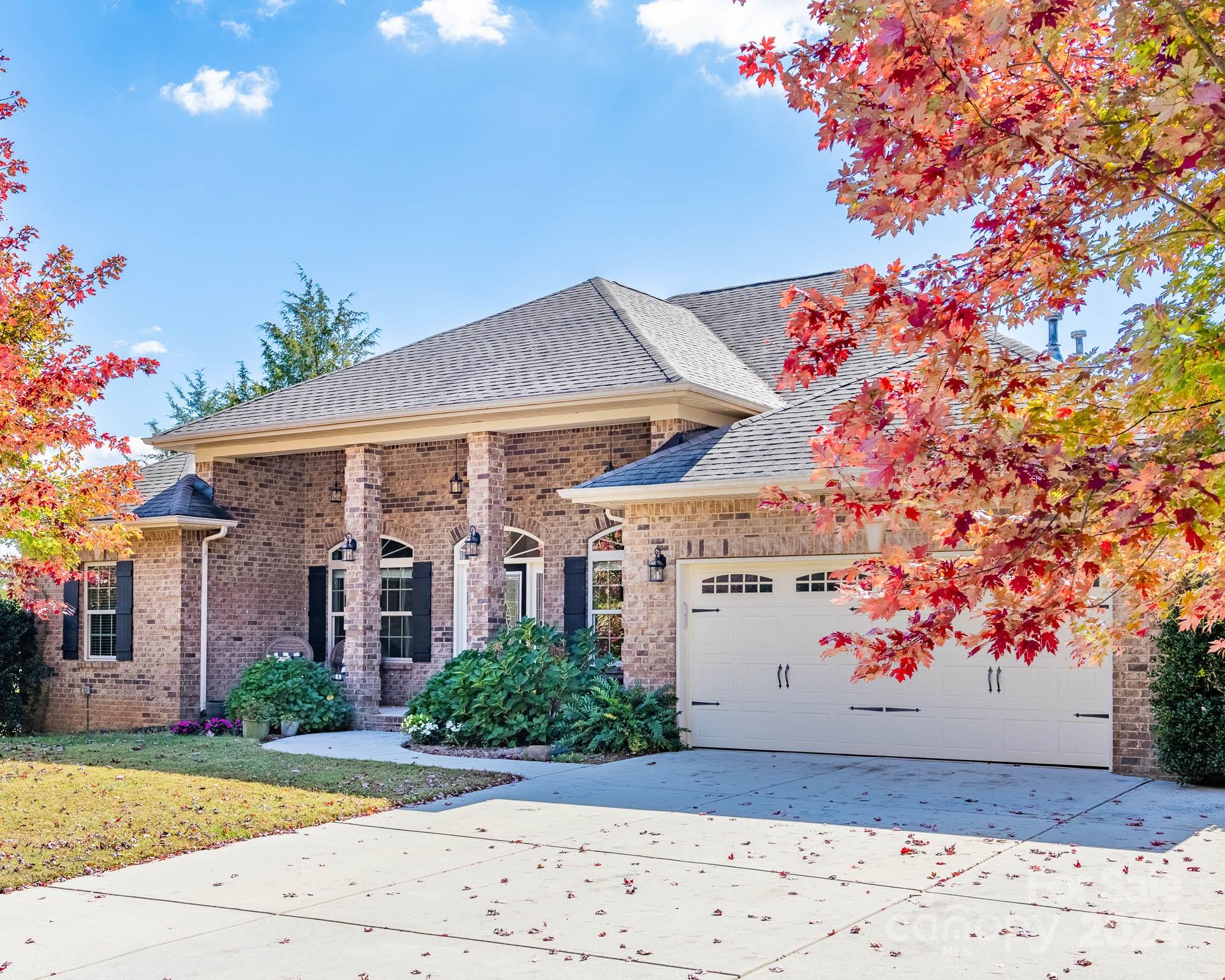 706 Houston Road Troutman, NC 28166 - Photo 3 of 39 a view of a white house with a yard and potted plants