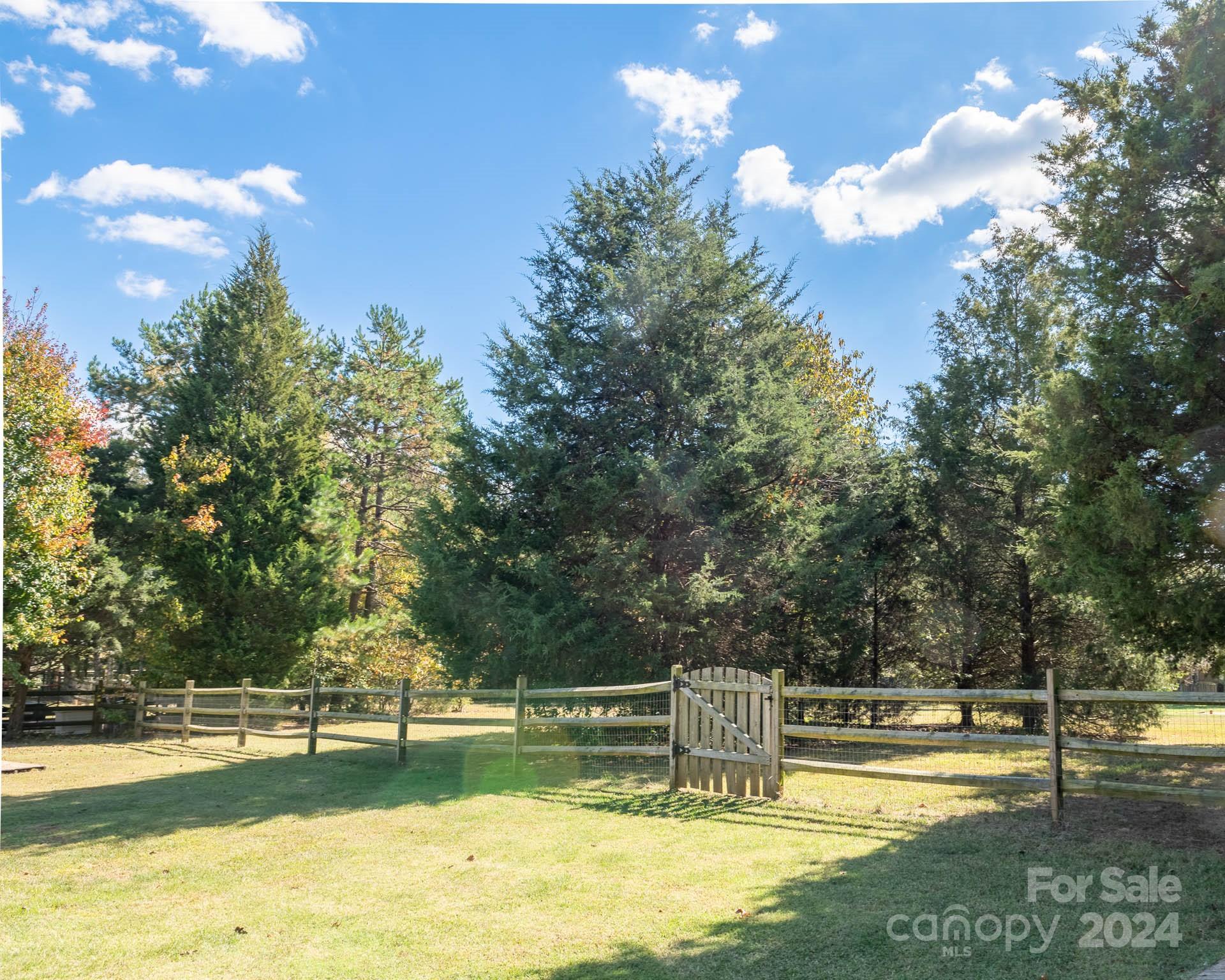 706 Houston Road Troutman, NC 28166 - Photo 32 of 39 a view of a swimming pool with an outdoor space and seating area