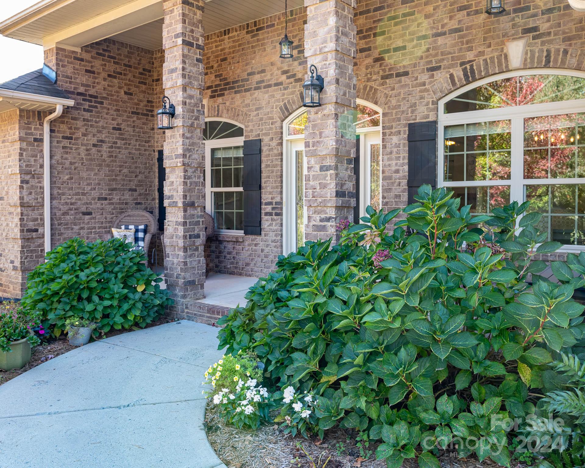 706 Houston Road Troutman, NC 28166 - Photo 4 of 39 front view of a brick house with a large windows