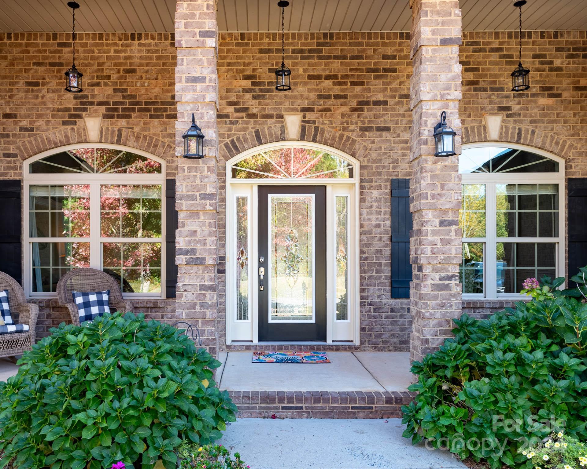706 Houston Road Troutman, NC 28166 - Photo 5 of 39 a front view of a building with a garden