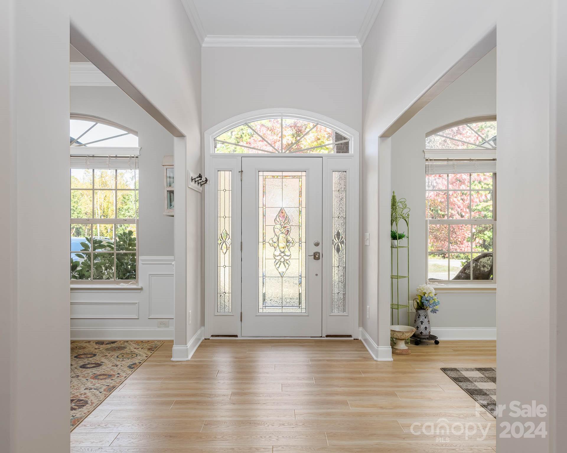 706 Houston Road Troutman, NC 28166 - Photo 6 of 39 an empty room with wooden floor and windows