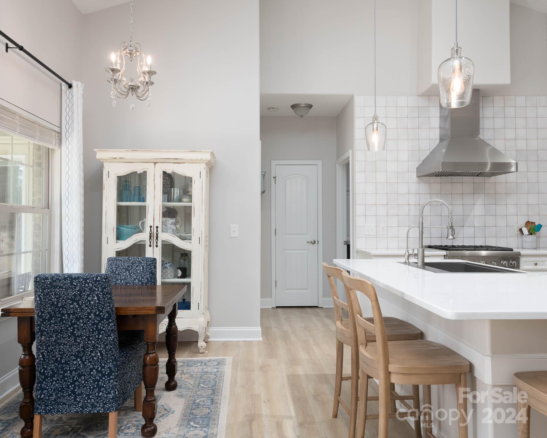 706 Houston Road Troutman, NC 28166 - Photo 9 of 39 a kitchen with a table chairs and a refrigerator