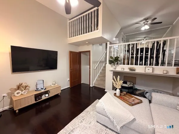 a living room with furniture and a wooden floor