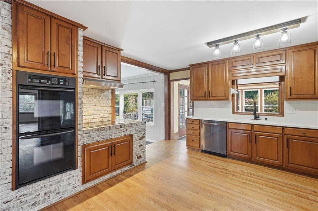 205 Hart Circle Dallas, GA 30132 - Photo 11 of 44 a kitchen with stainless steel appliances granite countertop a refrigerator a stove a sink and dishwasher with wooden floor