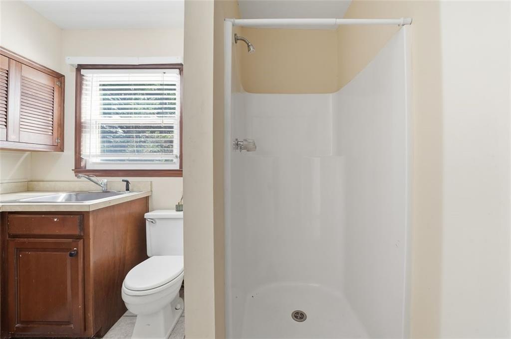 205 Hart Circle Dallas, GA 30132 - Photo 19 of 44 a bathroom with a granite countertop sink toilet and shower