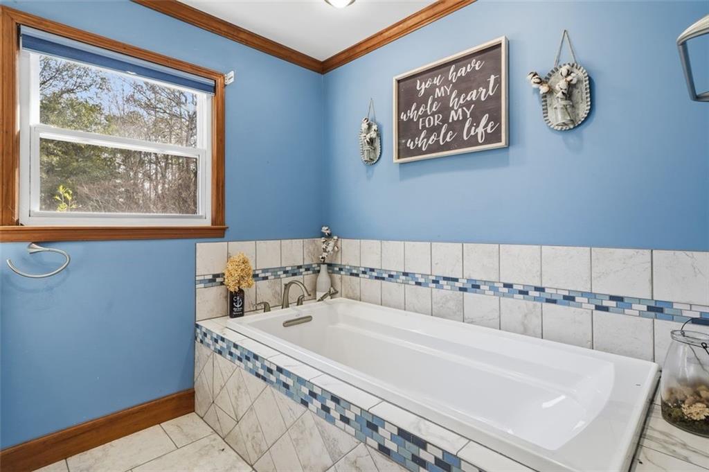 205 Hart Circle Dallas, GA 30132 - Photo 27 of 44 a bathroom with a tub and a window