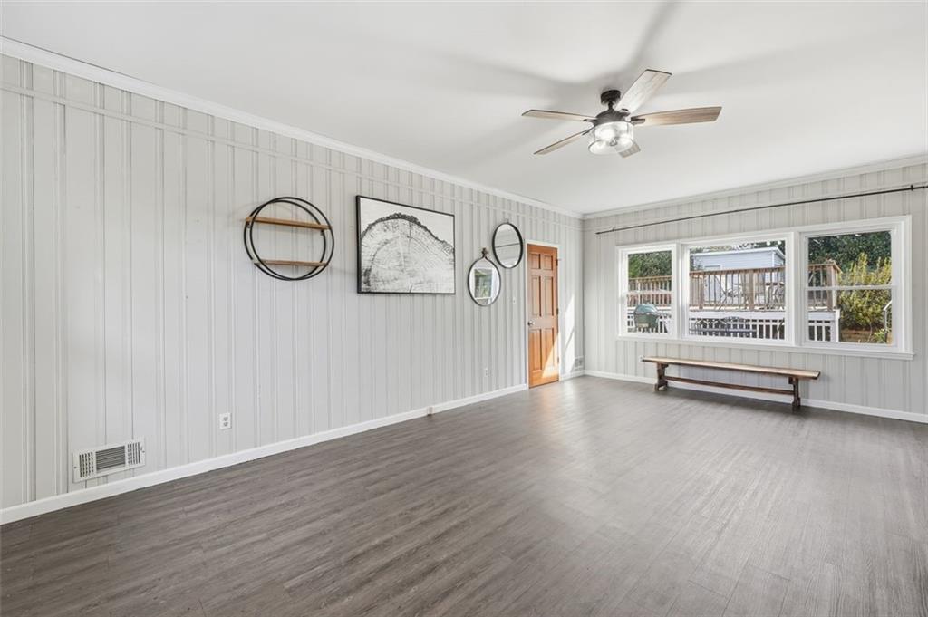 205 Hart Circle Dallas, GA 30132 - Photo 7 of 44 a view of a livingroom with wooden floor and a ceiling fan