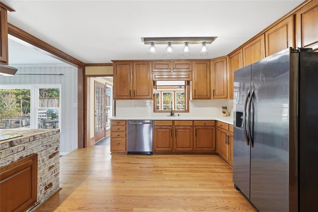 205 Hart Circle Dallas, GA 30132 - Photo 10 of 44 a large kitchen with stainless steel appliances granite countertop a refrigerator a sink dishwasher a stove with wooden cabinets and floor
