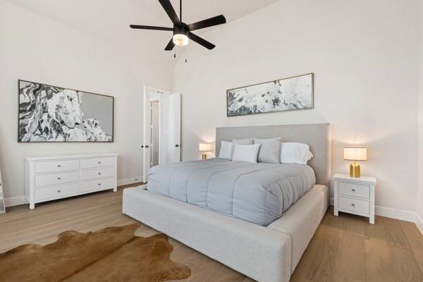 2432 Rose Run Way Celina, TX 75009 - Photo 16 of 26 a spacious bedroom with a bed and a painting on the wall