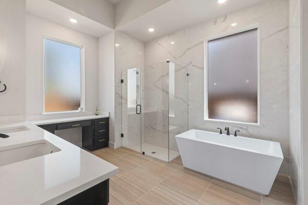 2432 Rose Run Way Celina, TX 75009 - Photo 18 of 26 a bathroom with a tub sink shower and mirror
