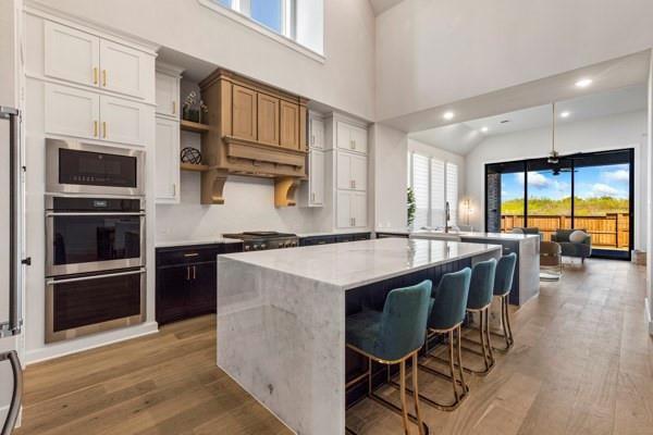 2432 Rose Run Way Celina, TX 75009 - Photo 4 of 26 a kitchen with stainless steel appliances granite countertop a stove a sink and a microwave