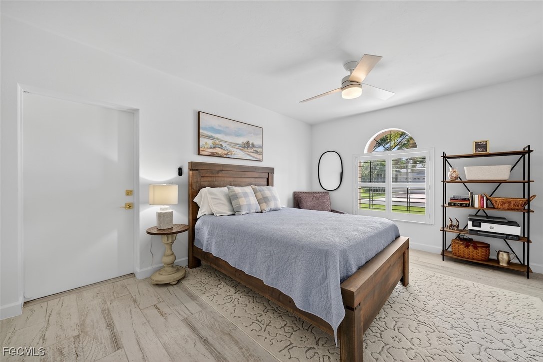 13570 Harbour Ridge Drive Fort Myers, FL 33908 - Photo 31 of 50 a bedroom with a bed a table and painting on the wall
