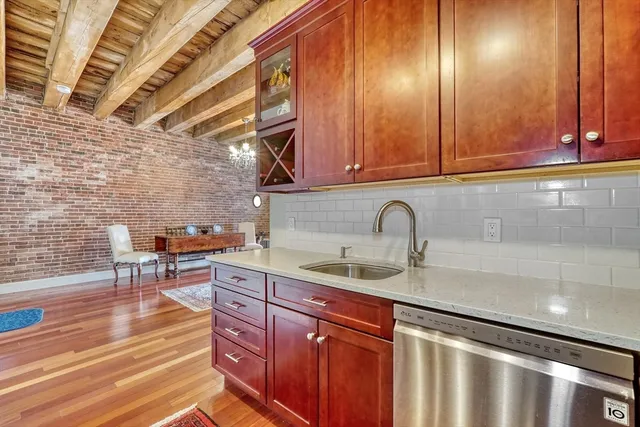 a living room with furniture a wooden floor and next to a window
