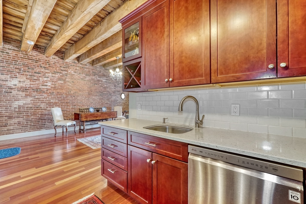 28-32 Atlantic Avenue, Unit 424 Boston, MA 02110 - Photo 11 of 38 a kitchen with a sink and cabinets