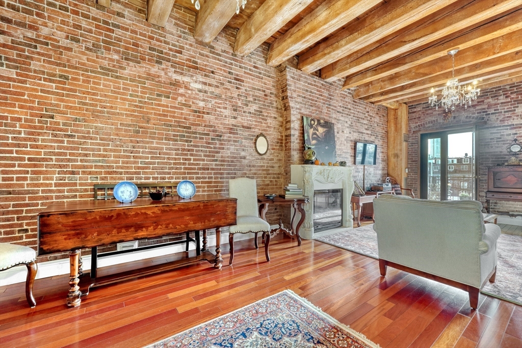 28-32 Atlantic Avenue, Unit 424 Boston, MA 02110 - Photo 12 of 38 a living room with furniture and wooden floor