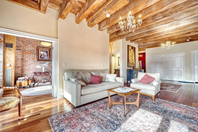 a view of a patio with couches chairs and wooden floor