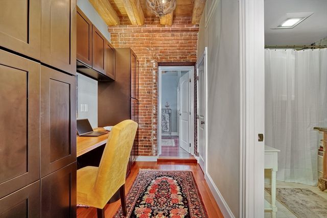 a room with wooden floor and furniture