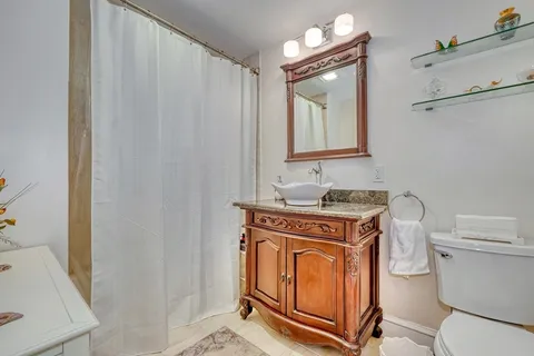 a bedroom with a bed a rug and chair