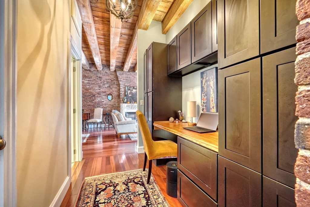 28-32 Atlantic Avenue, Unit 424 Boston, MA 02110 - Photo 22 of 38 a room with wooden floor and furniture