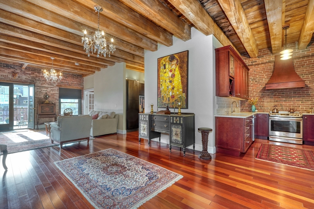 28-32 Atlantic Avenue, Unit 424 Boston, MA 02110 - Photo 7 of 38 a living room with furniture and wooden floor