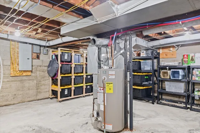 a view of a house with a yard and large tree