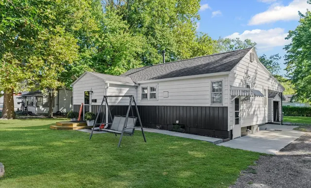 a view of a house with a backyard and patio