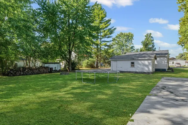 a view of a backyard with large trees