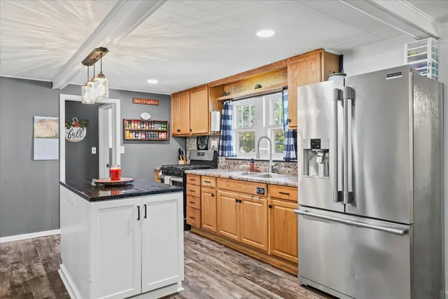 a kitchen with granite countertop a sink and a window