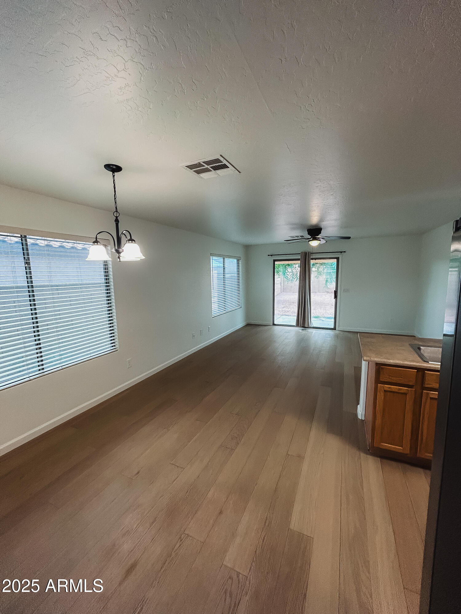 14857 West Hearn Road Surprise, AZ 85379 - Photo 12 of 20 a view of wooden floor and windows in a room