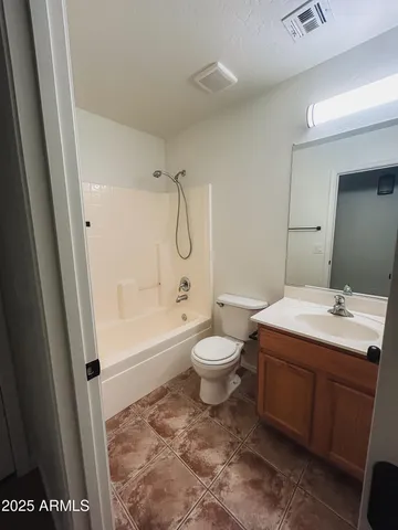 an empty room with a ceiling fan and window