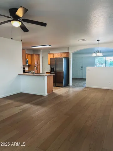 a view of a kitchen with a sink and a refrigerator