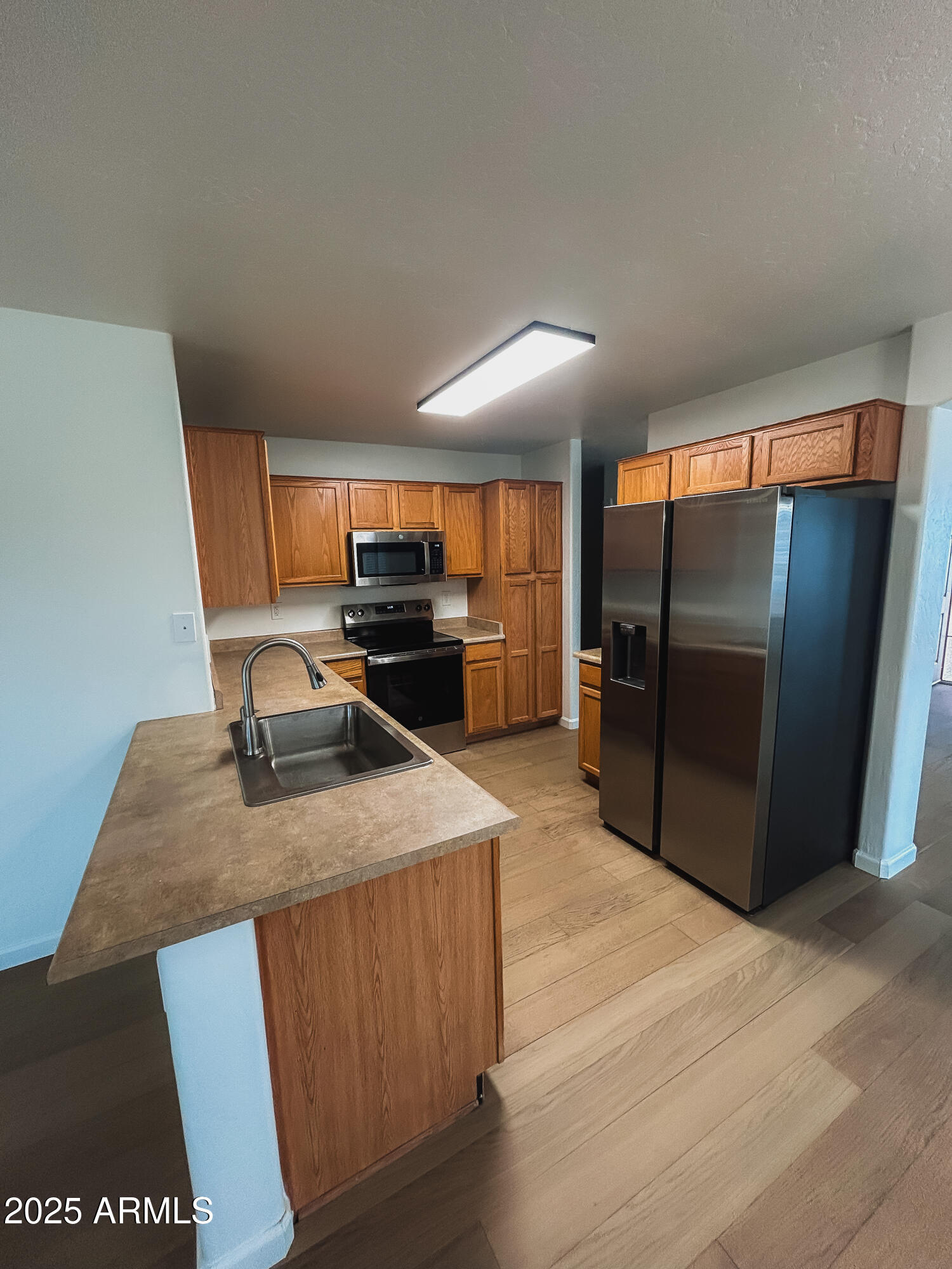 14857 West Hearn Road Surprise, AZ 85379 - Photo 5 of 20 a kitchen with stainless steel appliances granite countertop a refrigerator a stove and a sink