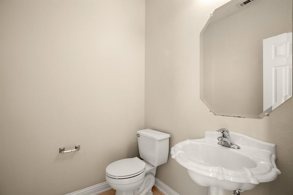 10105 Wind Cave Trail Austin, TX 78747 - Photo 20 of 23 Pedestal sink with chrome faucet, octagonal frameless mirror, and neutral wall tones