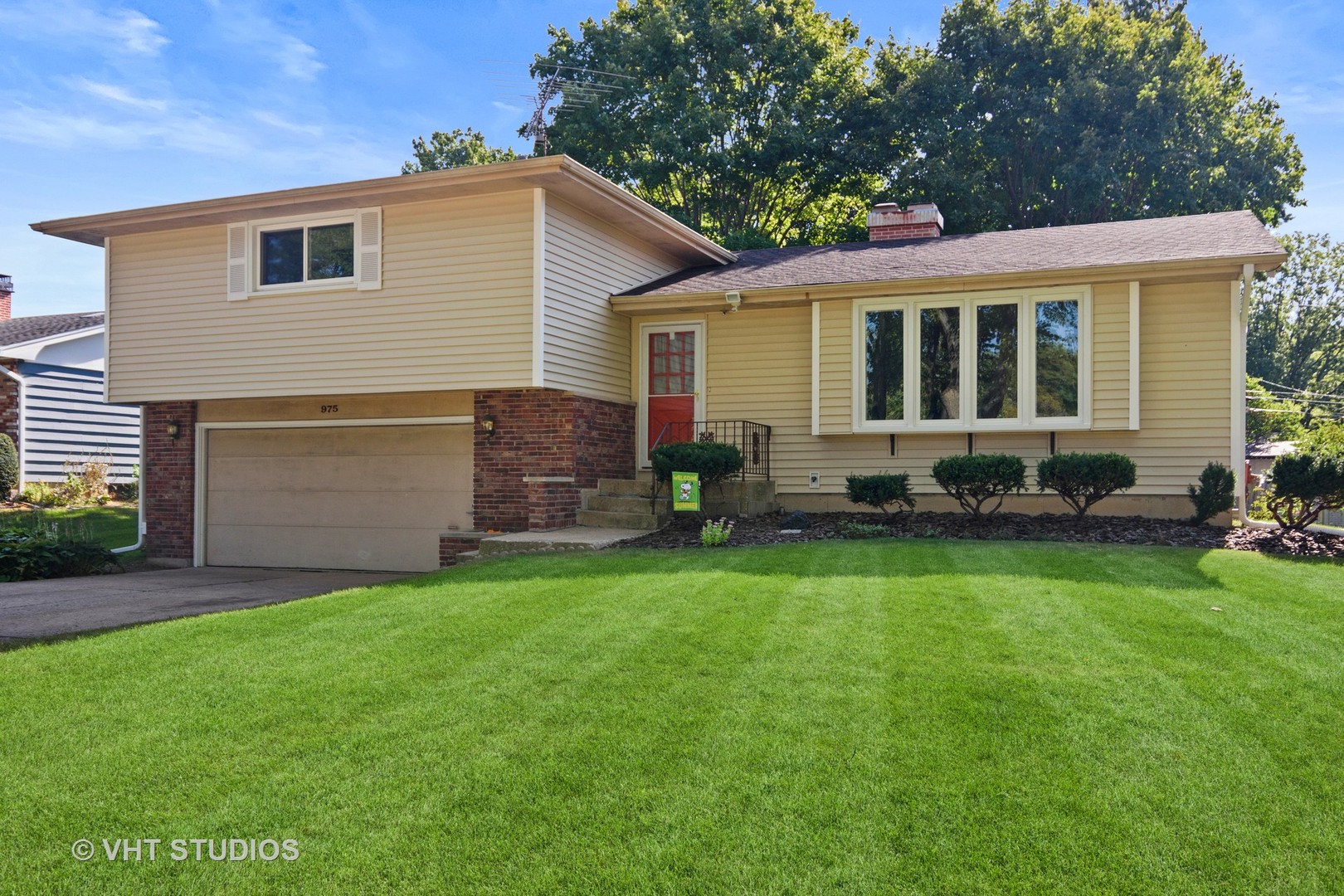 975 Ruth Drive Elgin, IL 60123 - Photo 1 of 17 a front view of house with yard and outdoor seating
