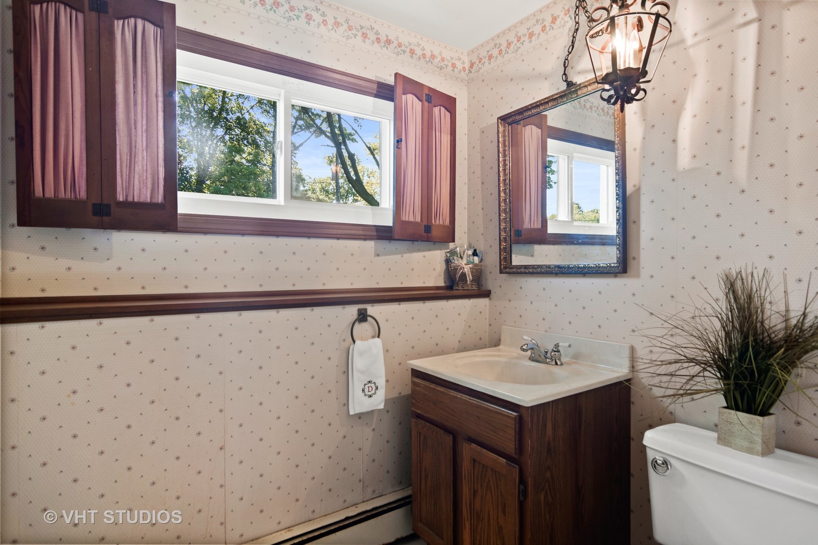 975 Ruth Drive Elgin, IL 60123 - Photo 15 of 17 a bathroom with a sink a toilet and a mirror