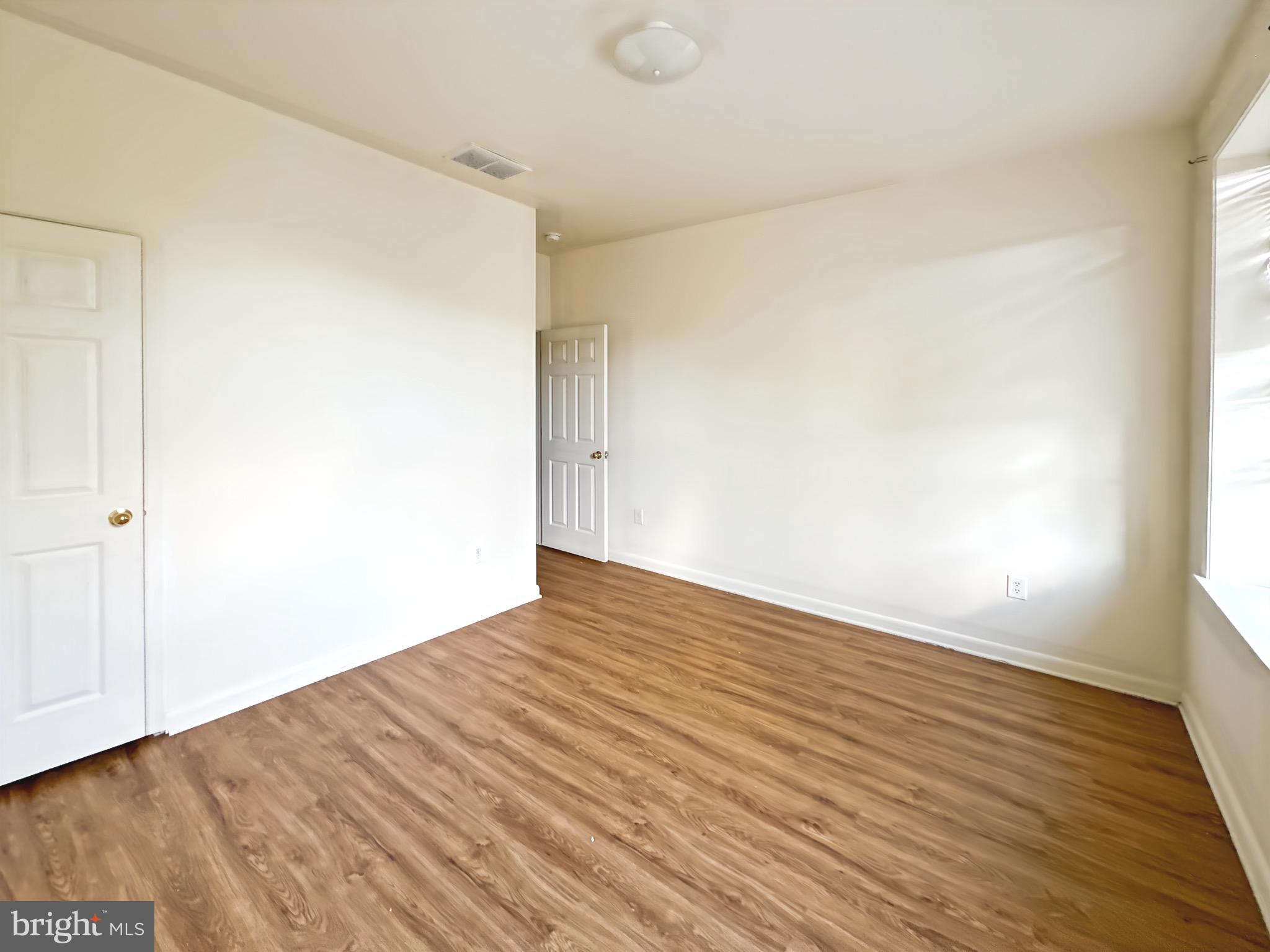 2426 Jefferson Street Baltimore, MD 21205 - Photo 11 of 17 a view of empty room with wooden floor