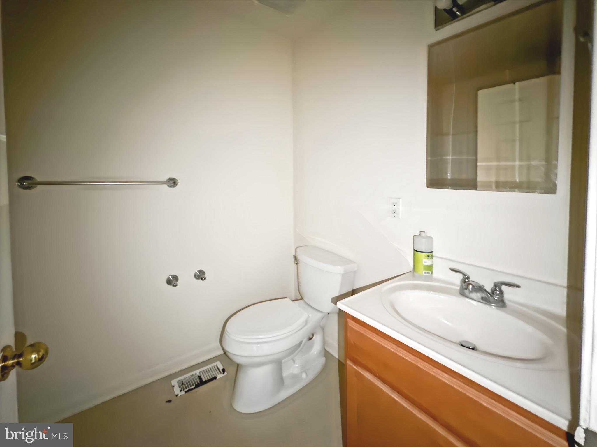 2426 Jefferson Street Baltimore, MD 21205 - Photo 13 of 17 a white toilet sitting next to a bathroom sink