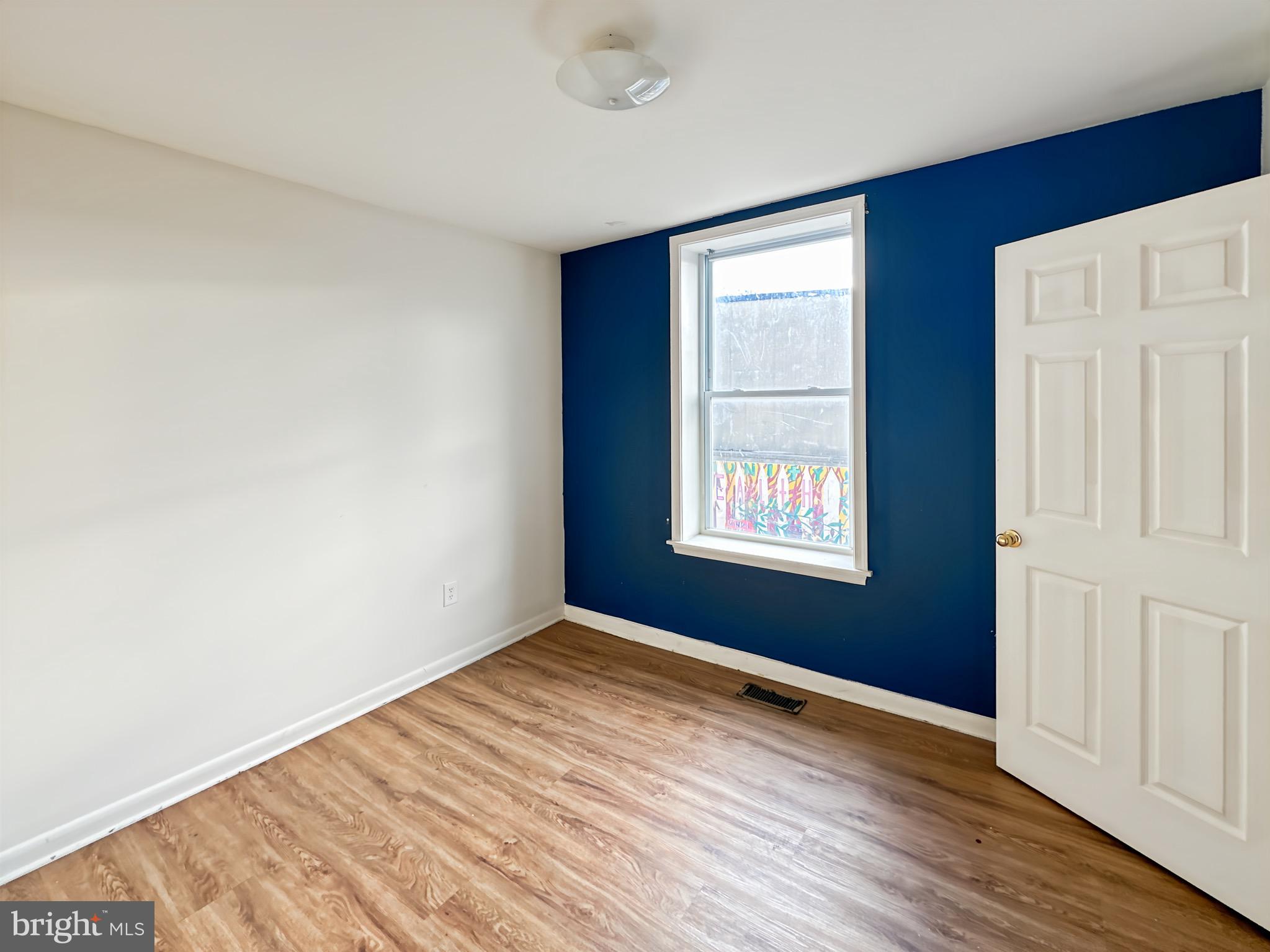 2426 Jefferson Street Baltimore, MD 21205 - Photo 14 of 17 an empty room with wooden floor and windows