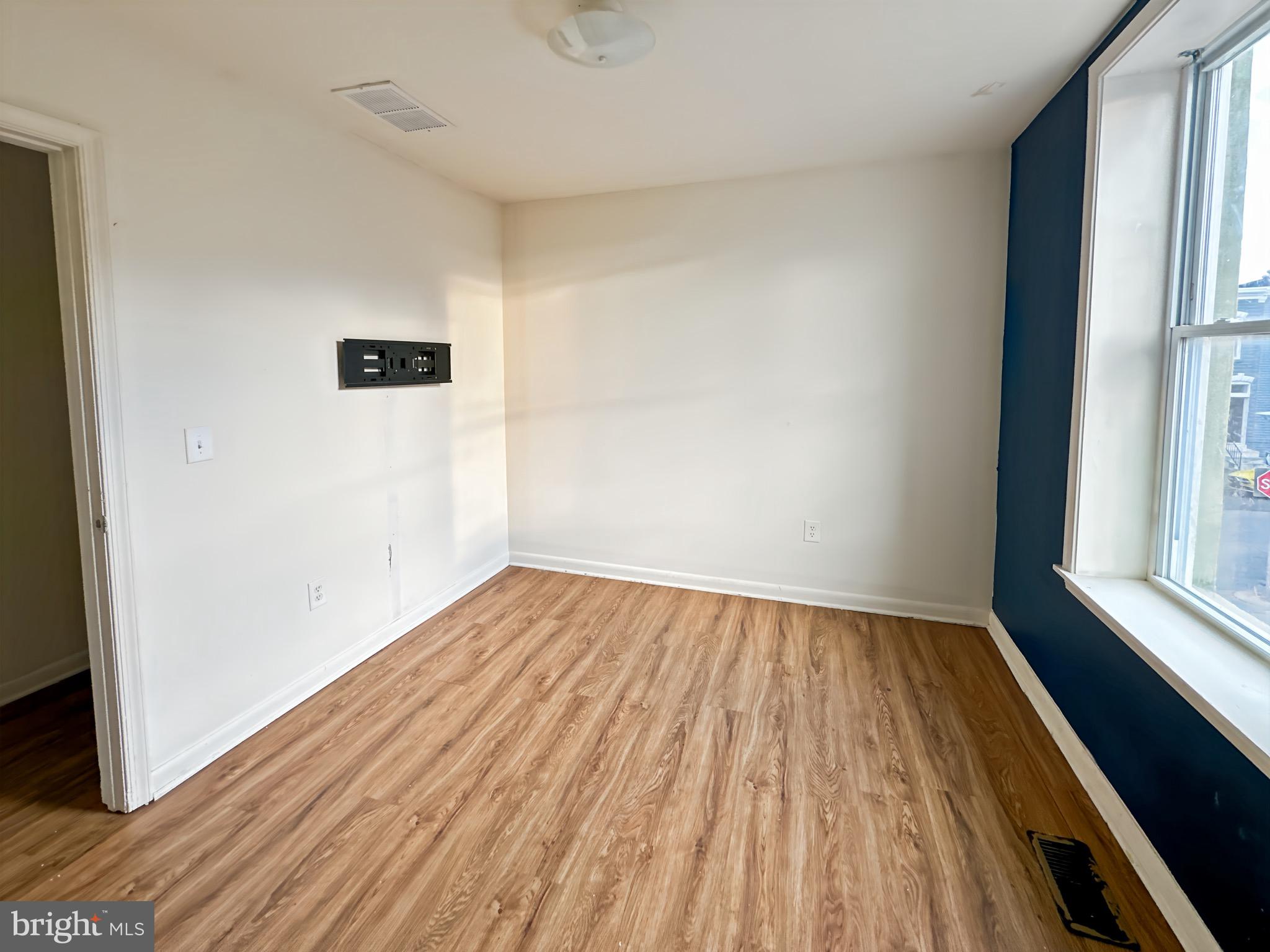 2426 Jefferson Street Baltimore, MD 21205 - Photo 15 of 17 an empty room with wooden floor and windows