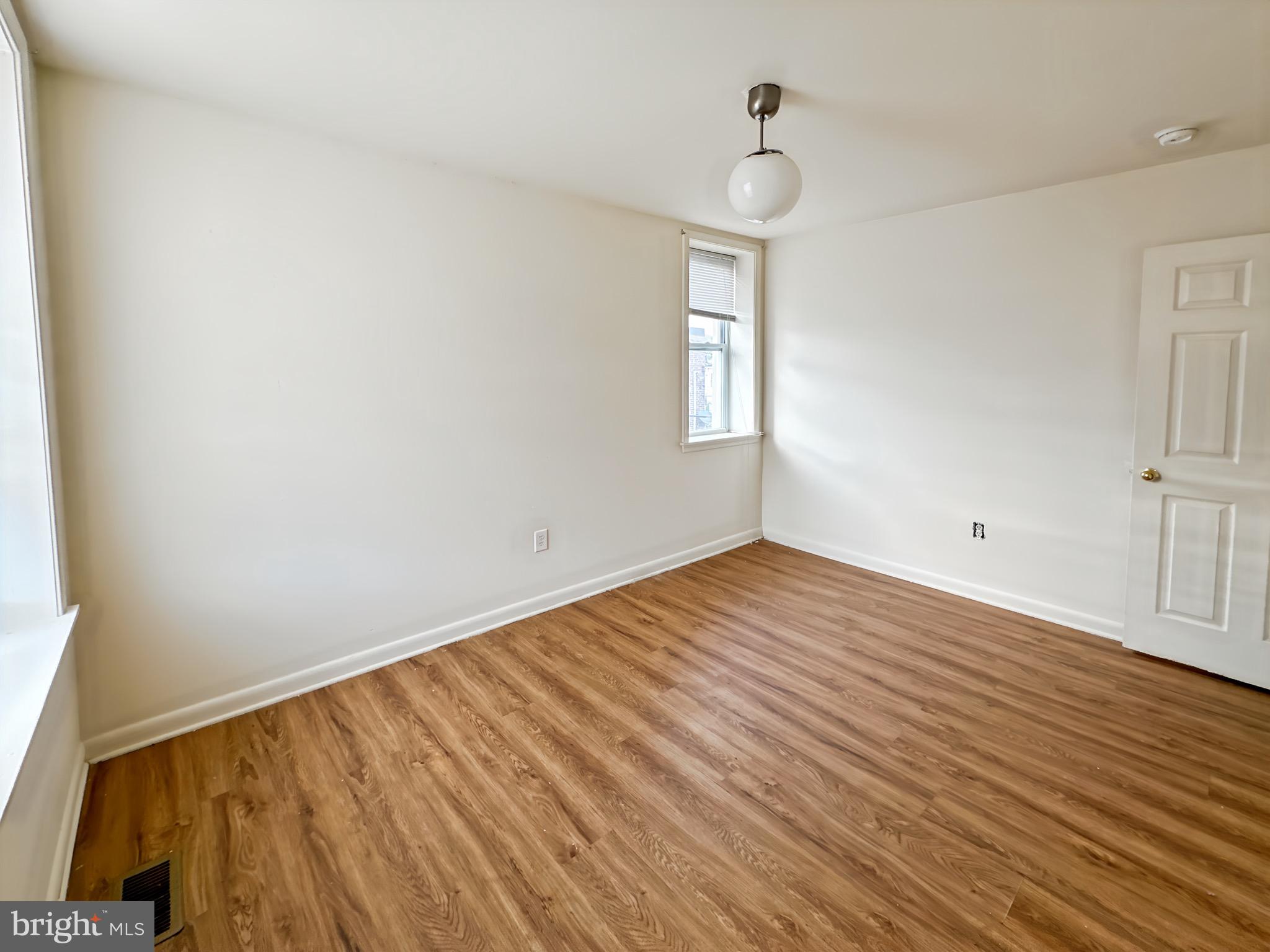 2426 Jefferson Street Baltimore, MD 21205 - Photo 16 of 17 a view of empty room with wooden floor and fan